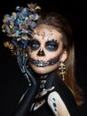 Halloween beauty portrait of a skeleton woman of death, the makeup on the face. Girl death Halloween costume. Day of The Dead.