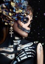 Halloween beauty skeleton woman makeup face Bokeh glitter. Girl death Halloween costume. Day of The Dead. Charming and dangerous