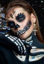 Halloween beauty skeleton woman makeup face Bokeh glitter. Girl death Halloween costume. Day of The Dead. Charming and dangerous