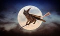 Halloween Black Cat on Broom Over Moon Royalty Free Stock Photo