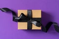 Halloween and black friday gift box with ribbon on purple background Royalty Free Stock Photo