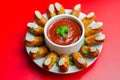 Halloween bloody fingers, pork cocktail sausages decorated with flaked almonds served with tomato and pepper dip Royalty Free Stock Photo