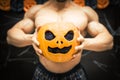 Halloween bodybuilder with pumpkin Royalty Free Stock Photo