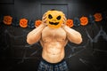 Halloween bodybuilder with pumpkin Royalty Free Stock Photo