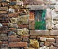 Halloween brick wall covered in spider web rags with window looking on a forest cabin and scary witch ghost Royalty Free Stock Photo