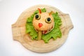 Halloween burger monsters ion wooden plate, food for kids party. Royalty Free Stock Photo