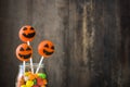 Halloween cake pops and colored candies on a rustic wooden background Royalty Free Stock Photo