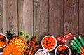 Halloween candy buffet border over a rustic wood background Royalty Free Stock Photo