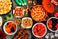 Halloween candy buffet table scene over a rustic wood background