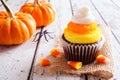 Halloween candy corn cupcake against white wood Royalty Free Stock Photo