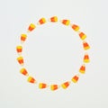 Halloween candy corn circle frame on a white background with copy space