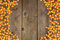 Halloween candy corn double side border on a wood background with copy space