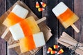 Halloween candy corn ice pops on rustic wood background Royalty Free Stock Photo