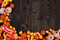 Halloween candy corner border over dark wood Royalty Free Stock Photo
