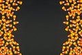 Halloween candy corn double side border on a black background with copy space