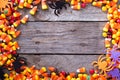 Halloween candy frame around rustic board Royalty Free Stock Photo