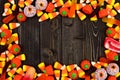 Halloween candy frame over dark wood Royalty Free Stock Photo