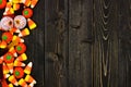 Halloween candy side border over dark wood Royalty Free Stock Photo