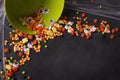 Halloween candy spilling out of a green bucket