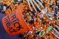 Halloween candy spilling out of orange trick or treat bucket