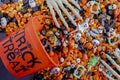 Halloween candy spilling out of orange trick or treat bucket