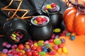 Halloween candy in trick or treat carry cauldrons closeup. Royalty Free Stock Photo