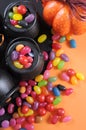 Halloween candy in trick or treat carry cauldrons - vertical closeup.