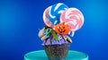 Halloween candyland drip cake style cupcakes with candy on blue background. Royalty Free Stock Photo