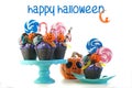 Halloween candyland drip cake style cupcakes with lollipops and candy on white. Royalty Free Stock Photo