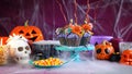 Halloween candyland drip cake style cupcakes in party table setting. Royalty Free Stock Photo