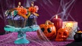 Halloween candyland drip cake style cupcakes in party table setting.