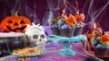 Halloween candyland drip cake style cupcakes in party table setting. Royalty Free Stock Photo