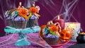 Halloween candyland drip cake style cupcakes in party table setting. Royalty Free Stock Photo