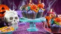 Halloween candyland drip cake style cupcakes in party table setting. Royalty Free Stock Photo