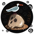 Halloween card. A seagull sits on a skull that lies on the sand