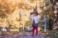 HALLOWEEN CELEBRATION CARD. Cute toddler girl in black witch hat costume party Royalty Free Stock Photo