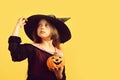 Halloween and celebration concept. Child in witch costume