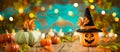 Halloween celebration concept with jack o lantern pumpkin and autumn leaves. Holiday banner