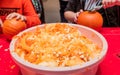 Halloween celebration in the shopping center. Children are carving a figure out of a pumpkin, Royalty Free Stock Photo