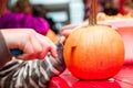 Halloween celebration in the shopping center. Master class for children on carving an evil Royalty Free Stock Photo