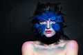 Halloween character concept. Model face with bird makeup on dark background Royalty Free Stock Photo