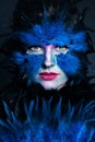 Halloween character make up. Woman with art makeup on blue background Royalty Free Stock Photo