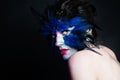 Halloween character. Model woman with blue bird makeup on black background Royalty Free Stock Photo