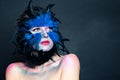 Halloween character portrait. Woman with creative blue bird makeup on dark background Royalty Free Stock Photo