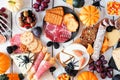 Halloween charcuterie overhead table scene against a white wood background
