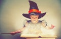 Halloween. cheerful little witch with a magic wand and glowing b Royalty Free Stock Photo