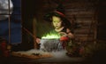Halloween. child girl witch preparing potion in cauldron