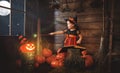 Halloween. child little witch with magic wand, pumpkin Jack mag Royalty Free Stock Photo