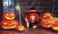 Halloween. child little witch with magic wand and pumpkin Jack Royalty Free Stock Photo