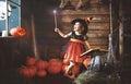 Halloween. child little witch with magic wand and reading a mag Royalty Free Stock Photo